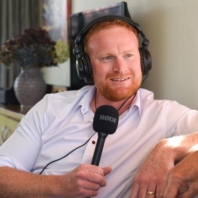 jordan-brannigan-life-story-studio-bay-of-plenty.jpg Jordan Brannigan, NZ Radio Award-winning broadcaster and founder of Life Story Studio, holding a microphone during an interview.